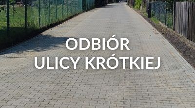 Grafika przedstawia przebudowaną ul. Krótką. Na grafice widnieje także napis "Odbiór ul. Krótkiej".